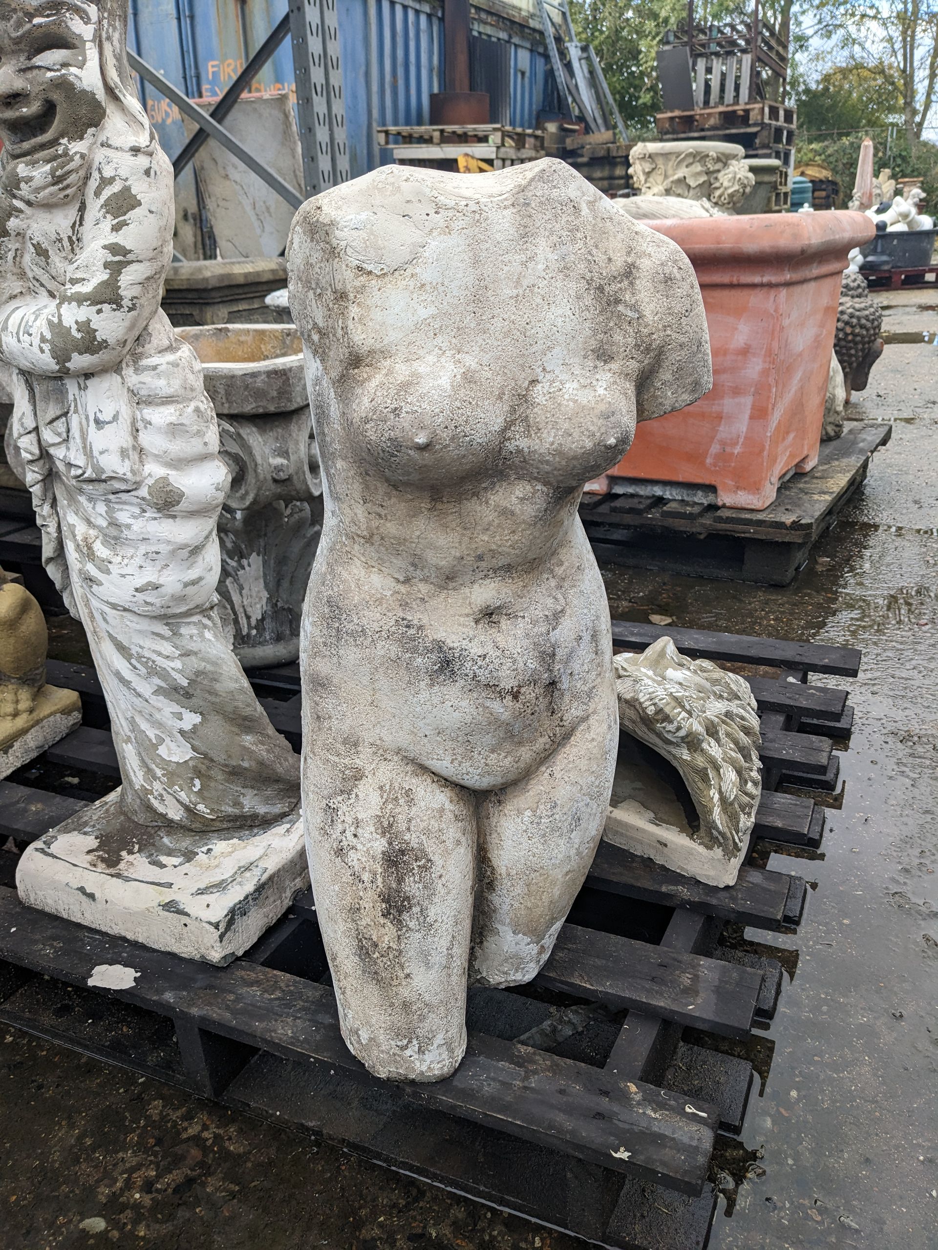 female torso stone garden statue