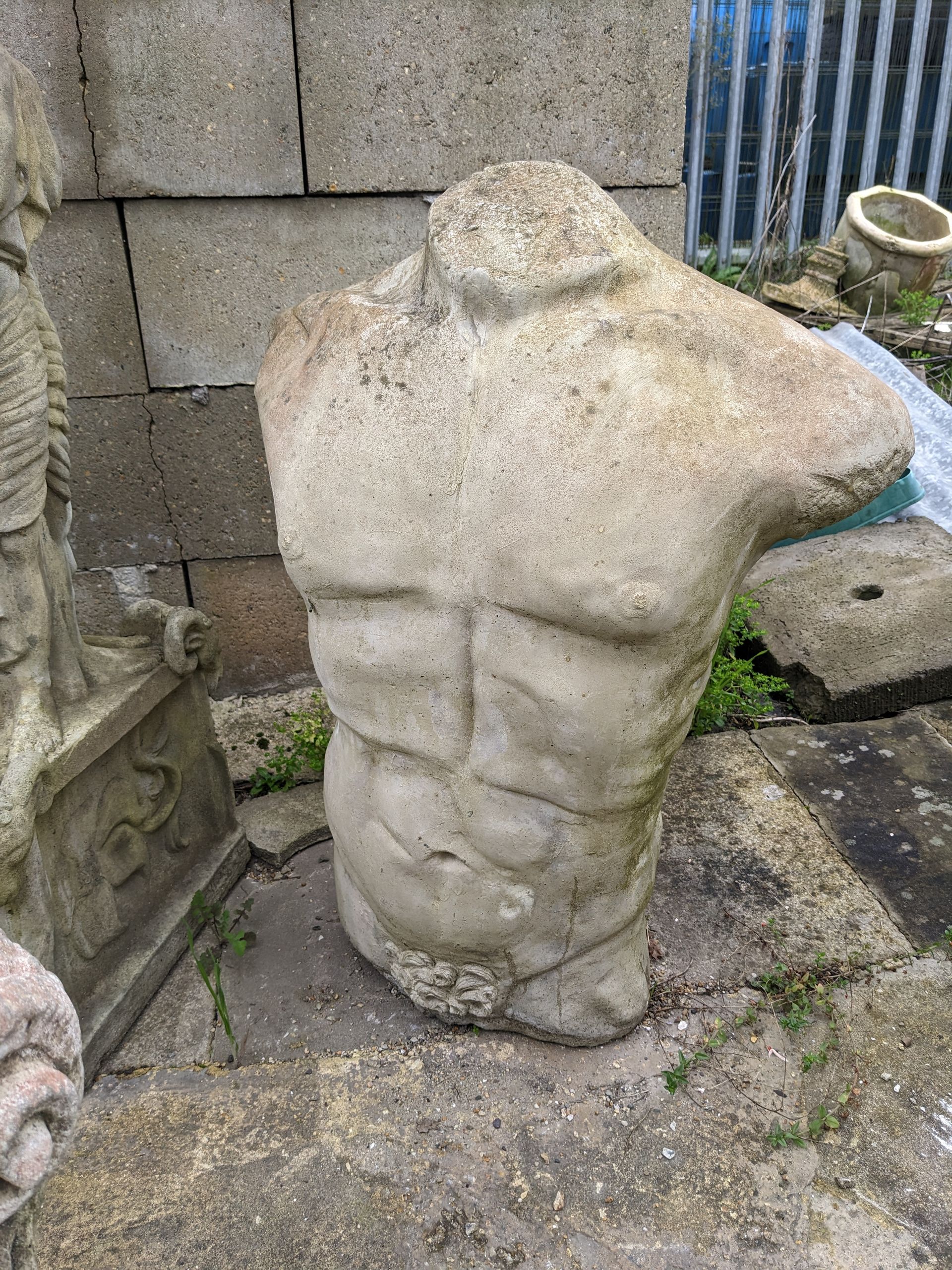 male torso stone garden statue