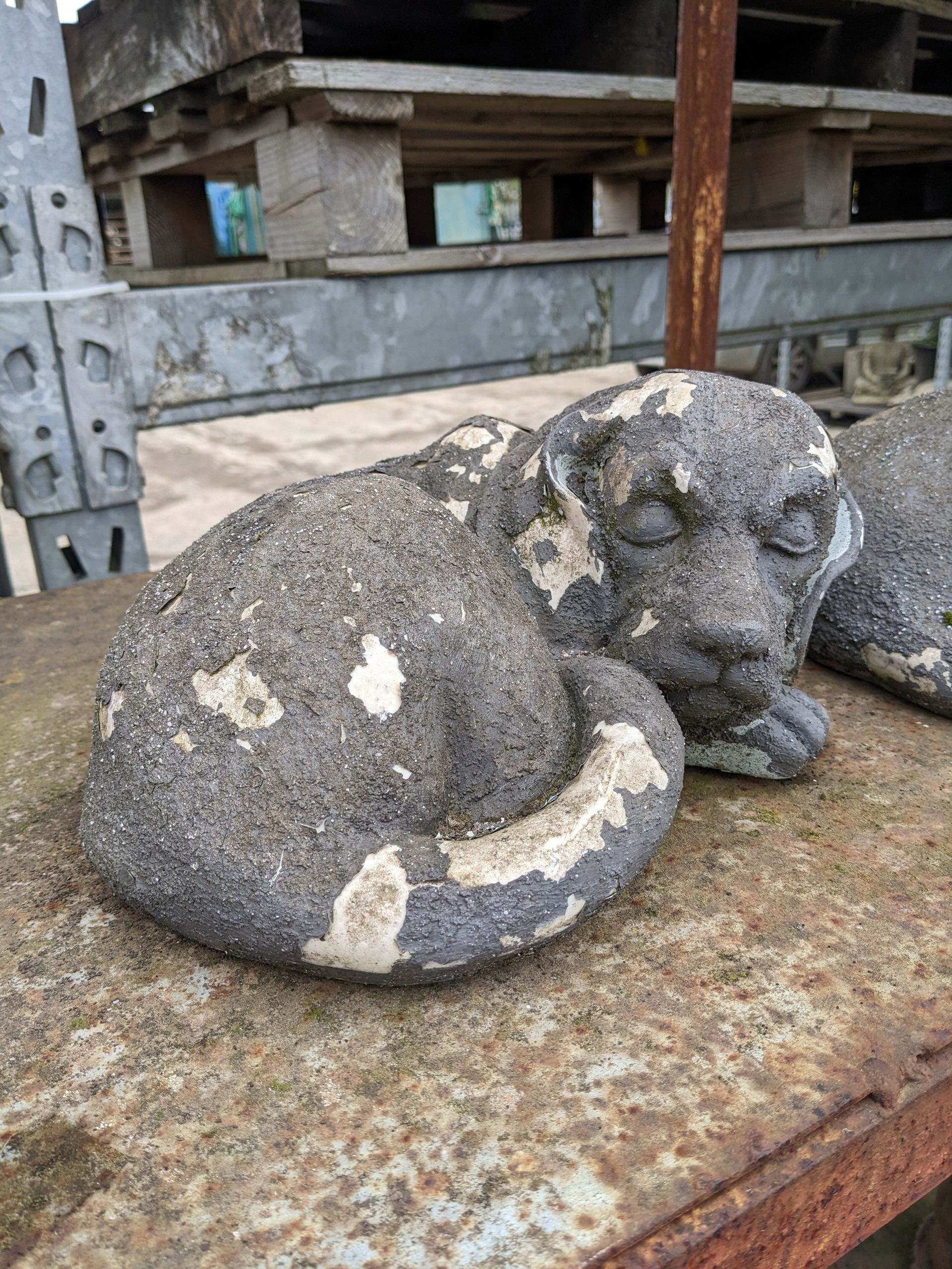 dog puppy curled up stone garden statue