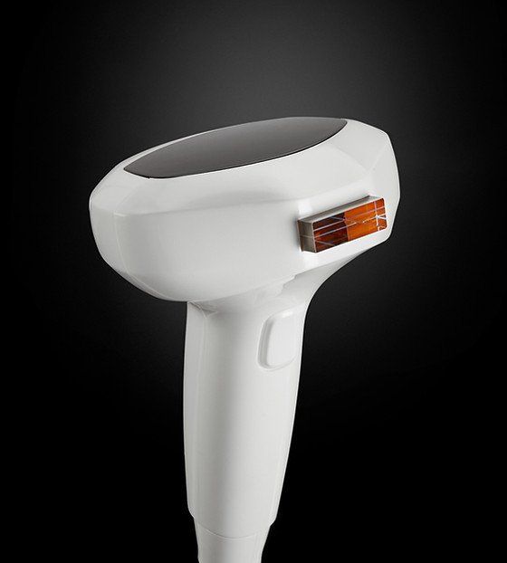 A close up of a hair removal device on a black background.