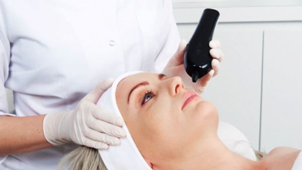 A woman is getting a plasma IQ treatment at a med spa.