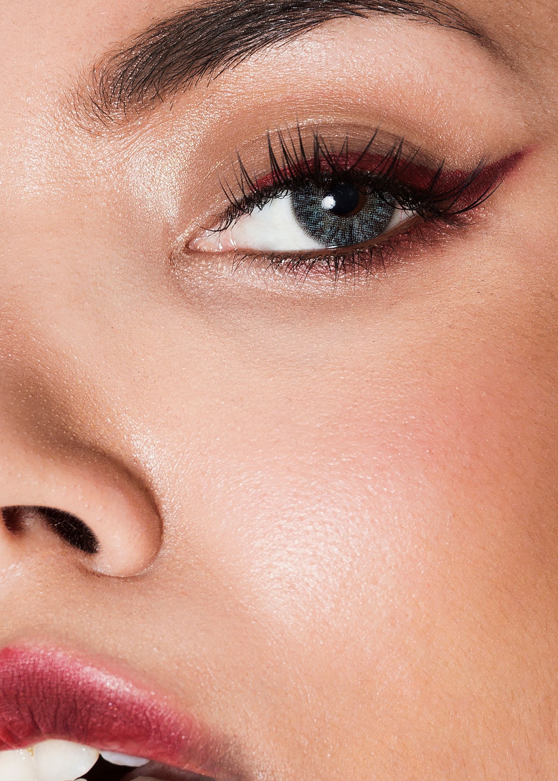 A close up of a woman 's face with makeup on.