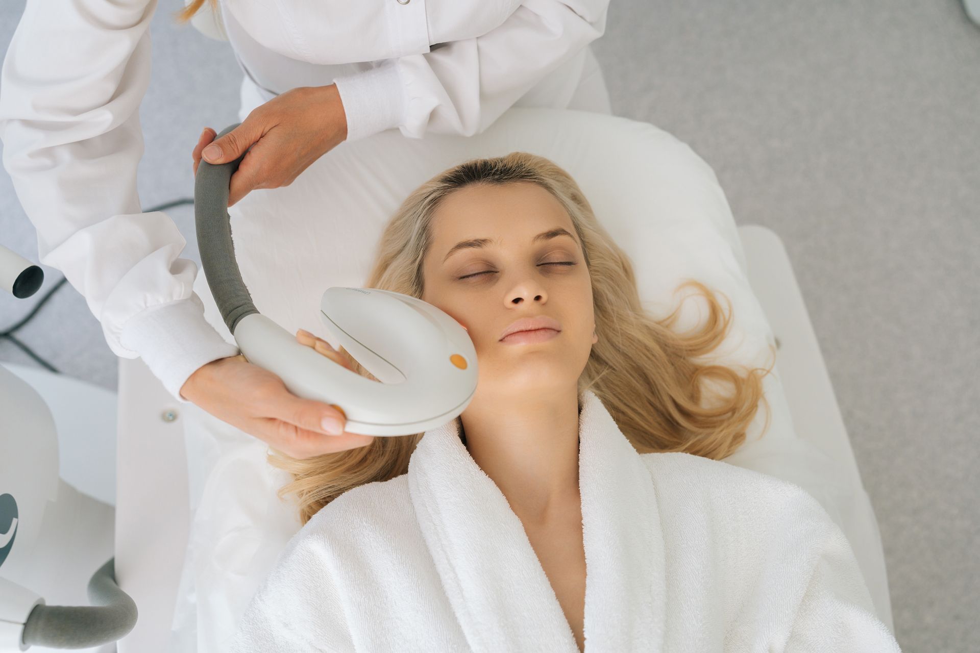 A woman is getting a facial treatment at a beauty salon.