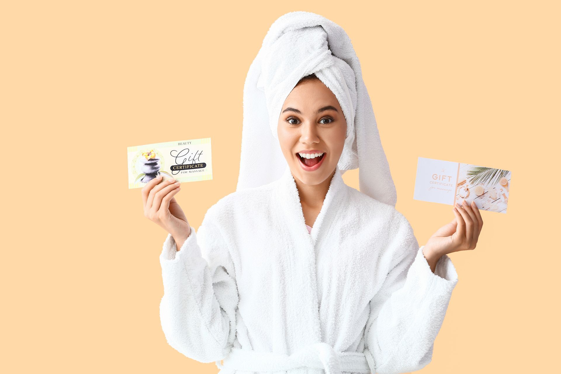 Smiling person in a white robe and towel holds two skincare cards against a peach background