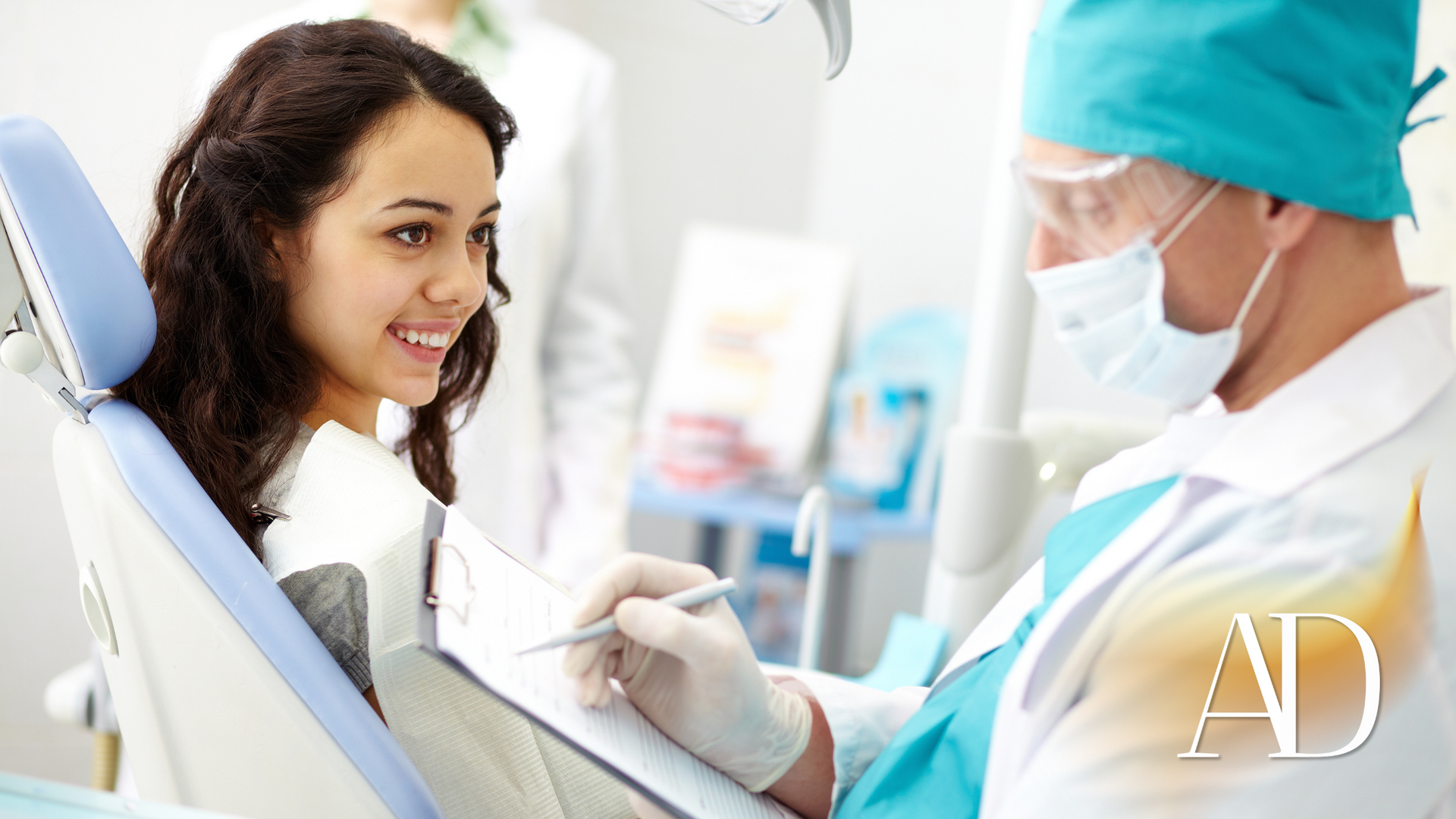 Dentist examining a smiling patient in a bright dental clinic