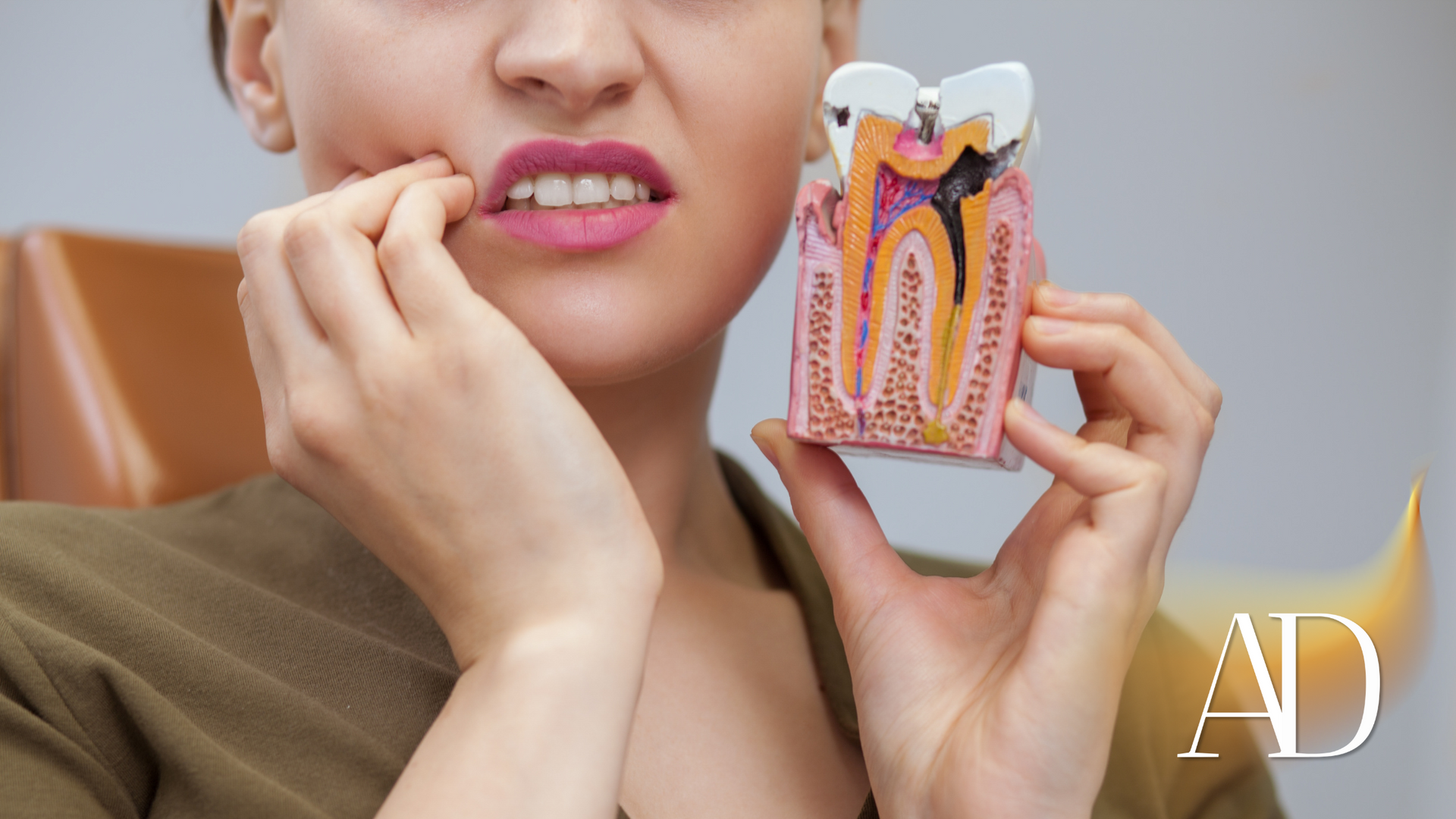 Woman holding a dental product while touching her mouth, suggesting tooth pain; “AD” label in corner