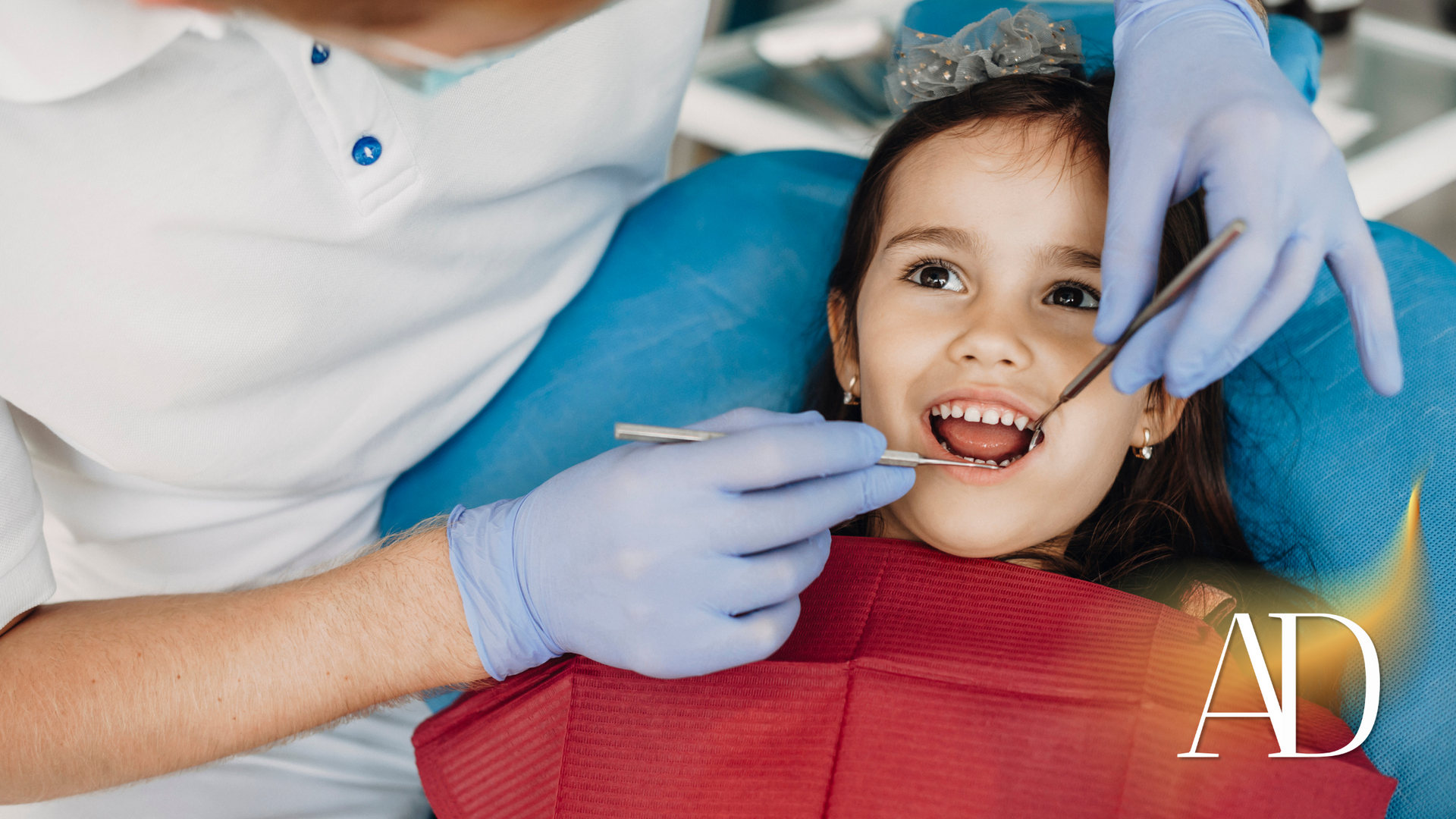 Dentist examining a smiling child’s mouth with gloved hands in a bright clinic