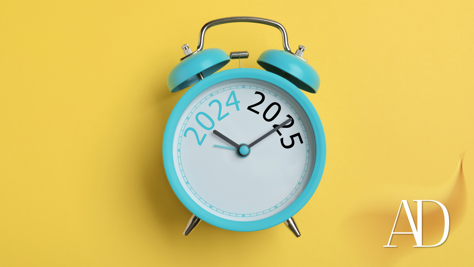 Blue alarm clock with 2024 and 2025 on the face against a yellow background