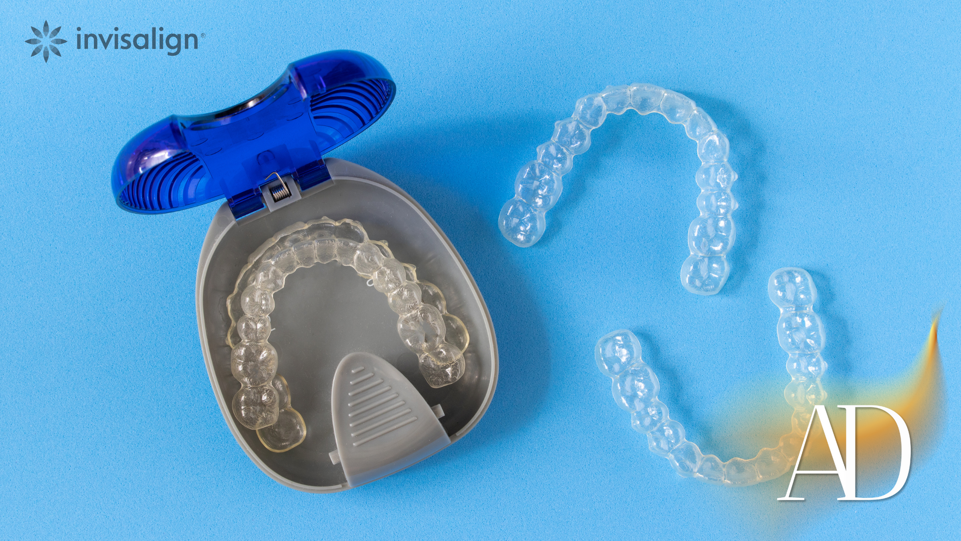 Invisalign braces case with clear aligners and a blue teeth-whitening tray on a blue background