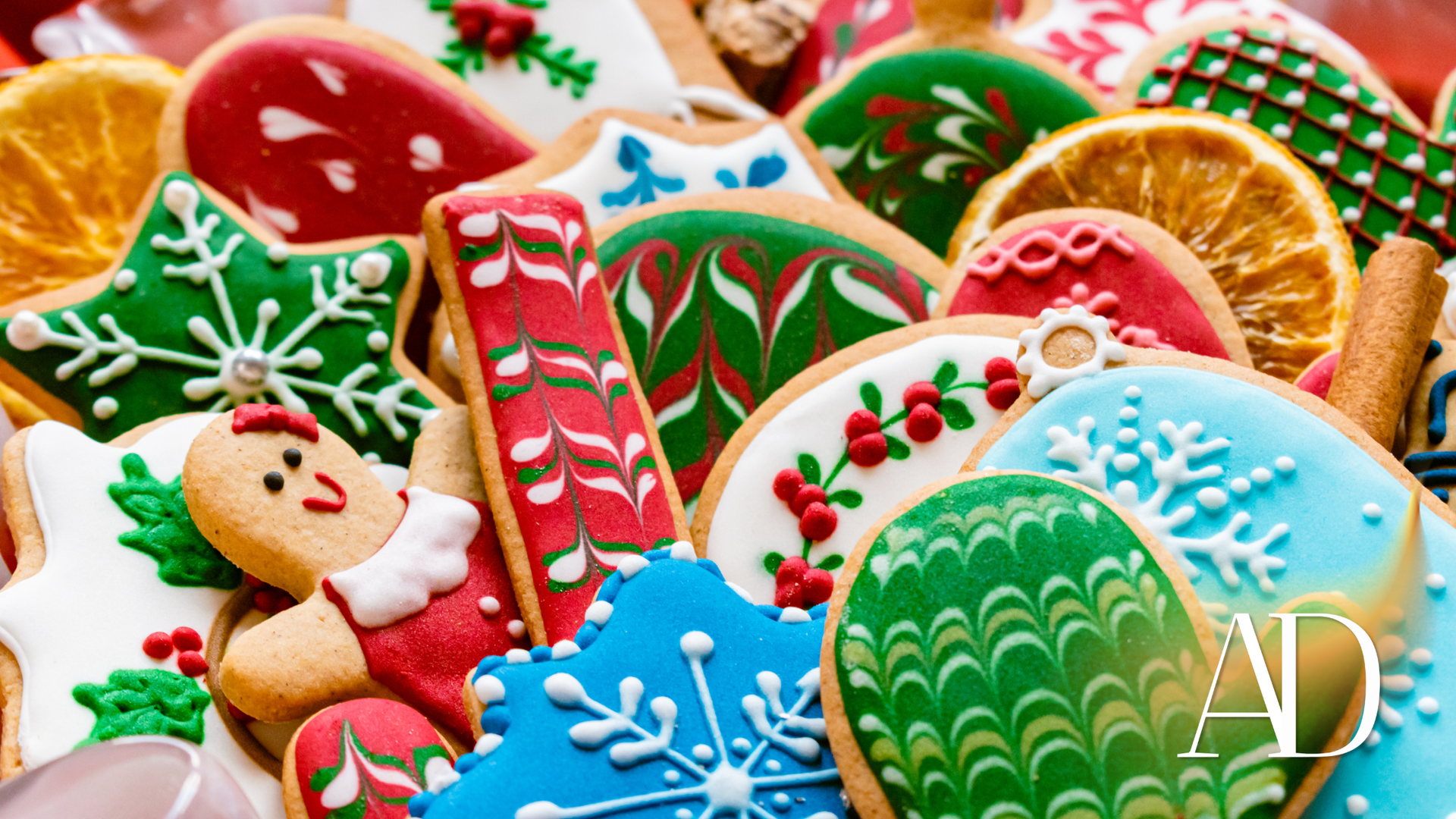 Colorful decorated Christmas cookies with icing, candy canes, holly, and festive holiday patterns.