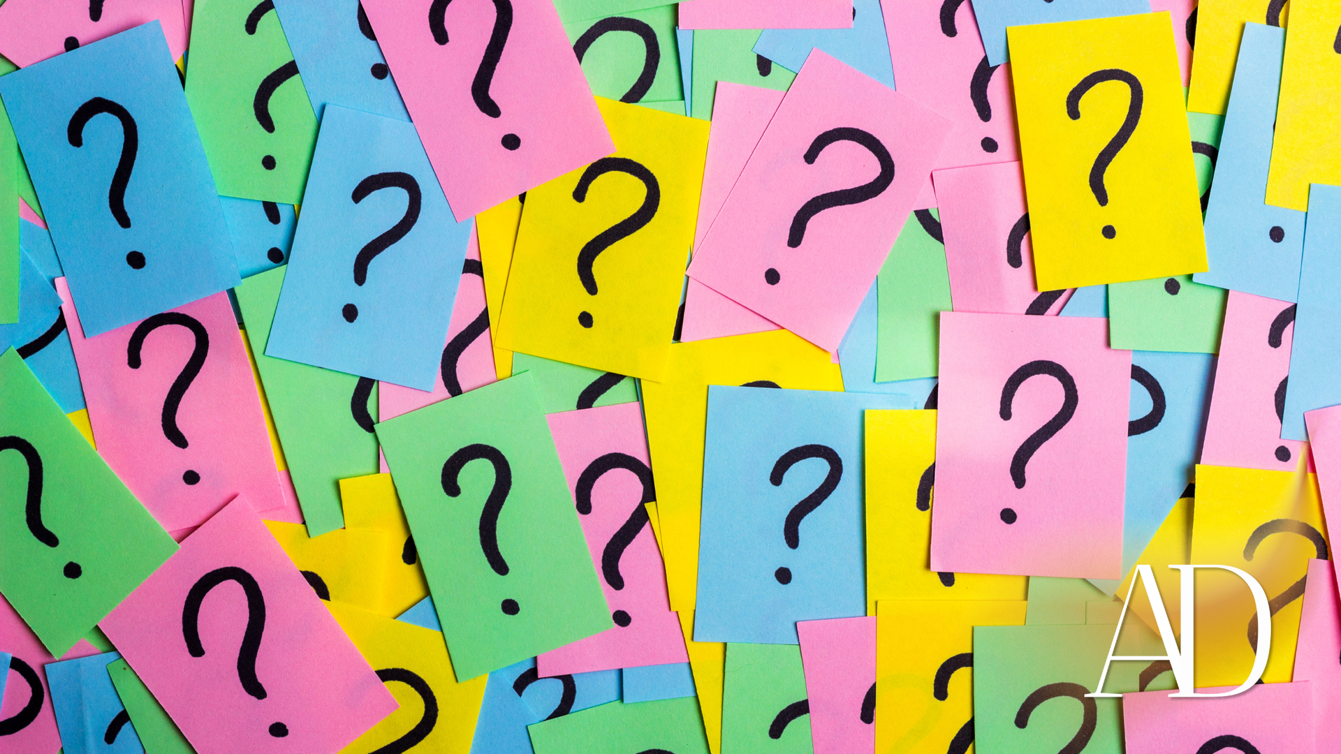 Colorful sticky notes with large question marks scattered across a teal background