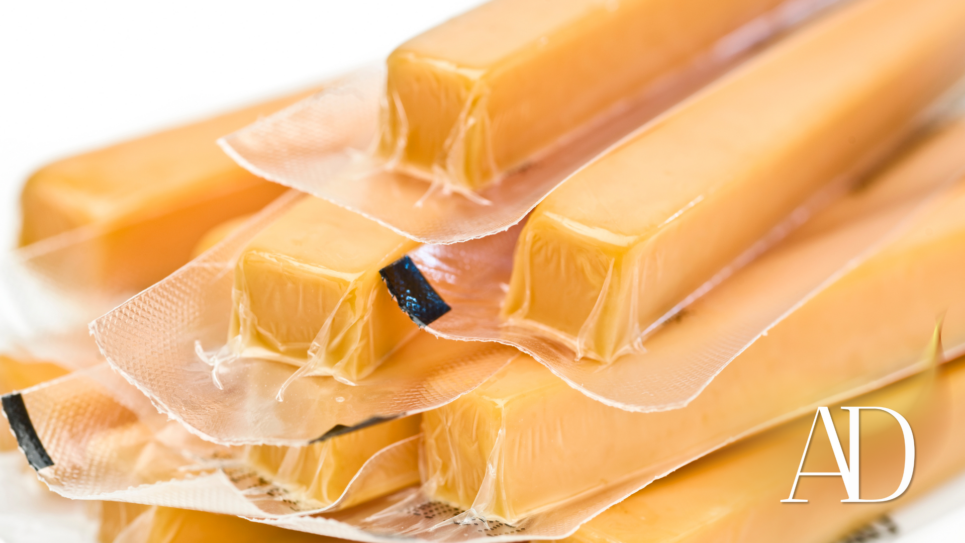 Stacked caramel-colored wrapped snack bars with some wrappers partially peeled back