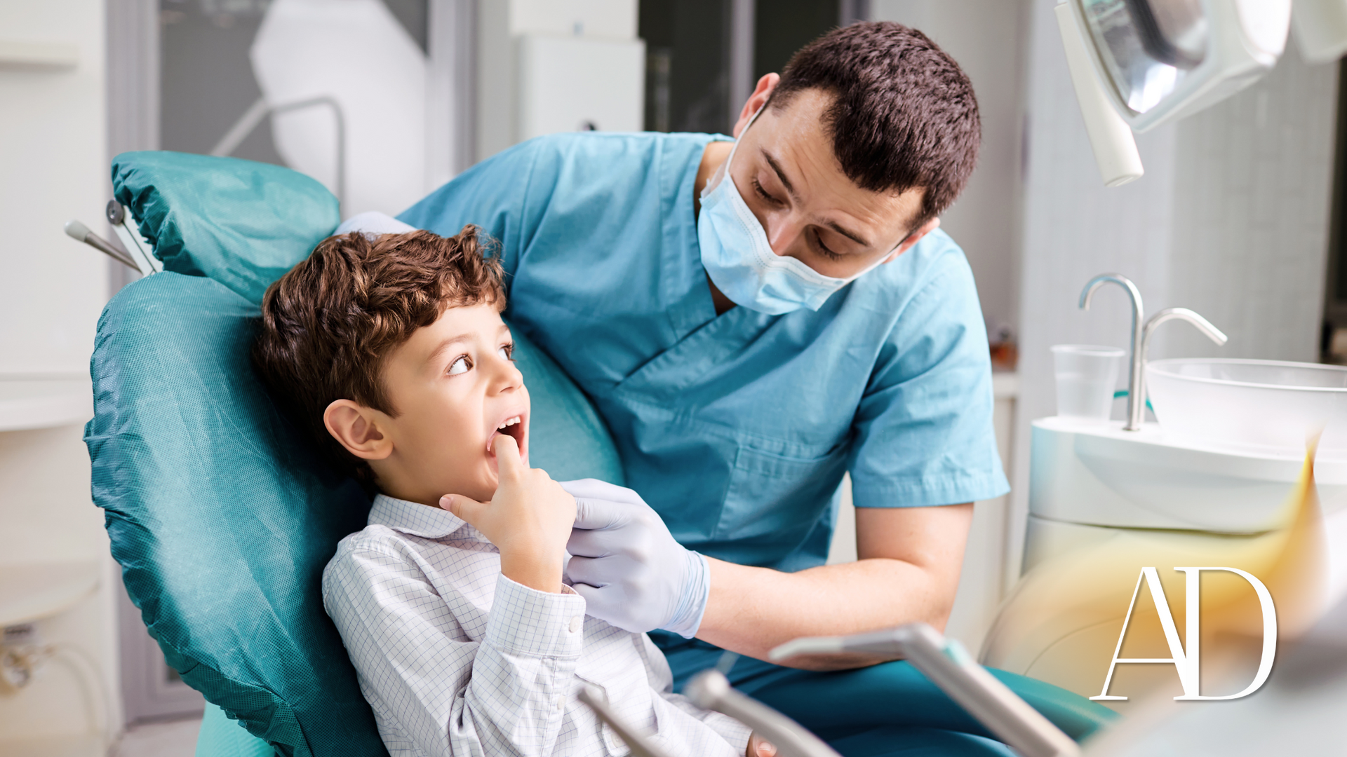 Dentist examining a child in a dental chair, with blue gloves and a bright clinic setting