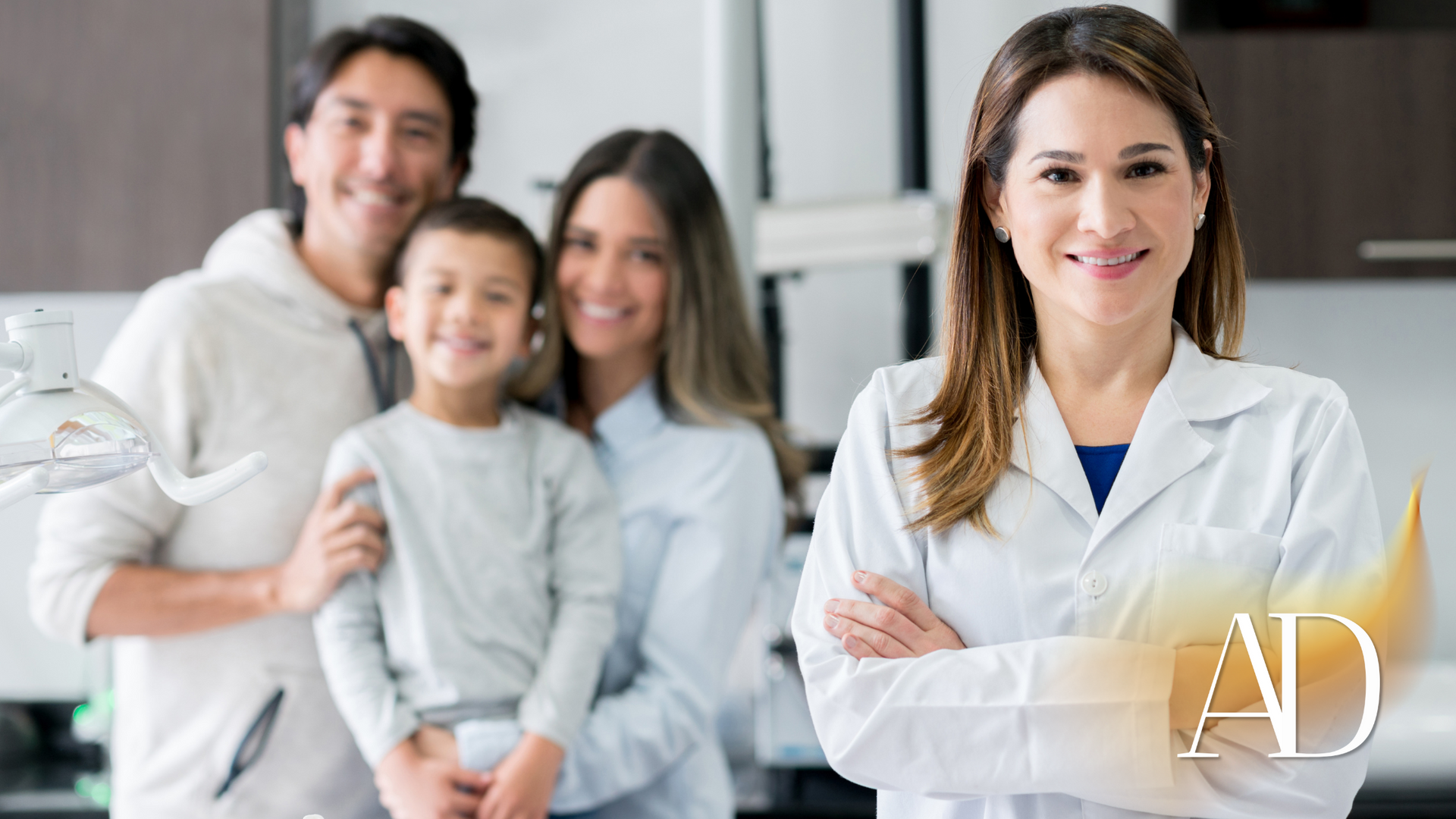 Doctor with arms crossed in a clinic, with a family standing together in the background.