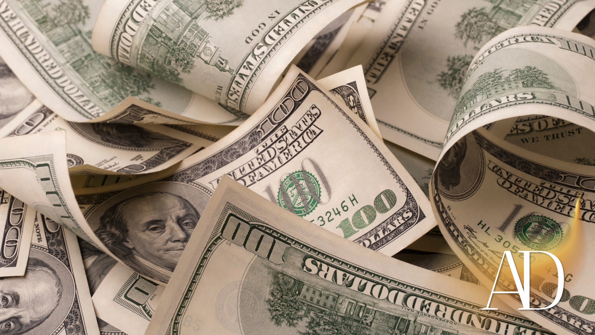 Scattered U.S. dollar bills in close-up, showing crumpled cash and Benjamin Franklin portraits