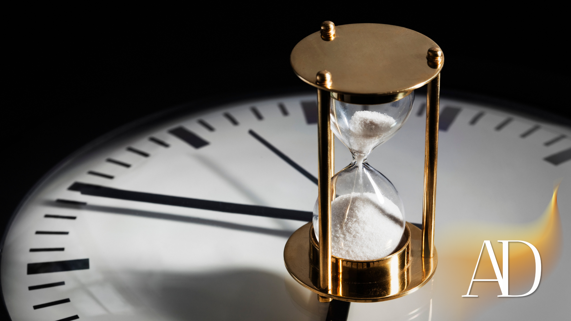 Hourglass on a clock face, symbolizing time passing.