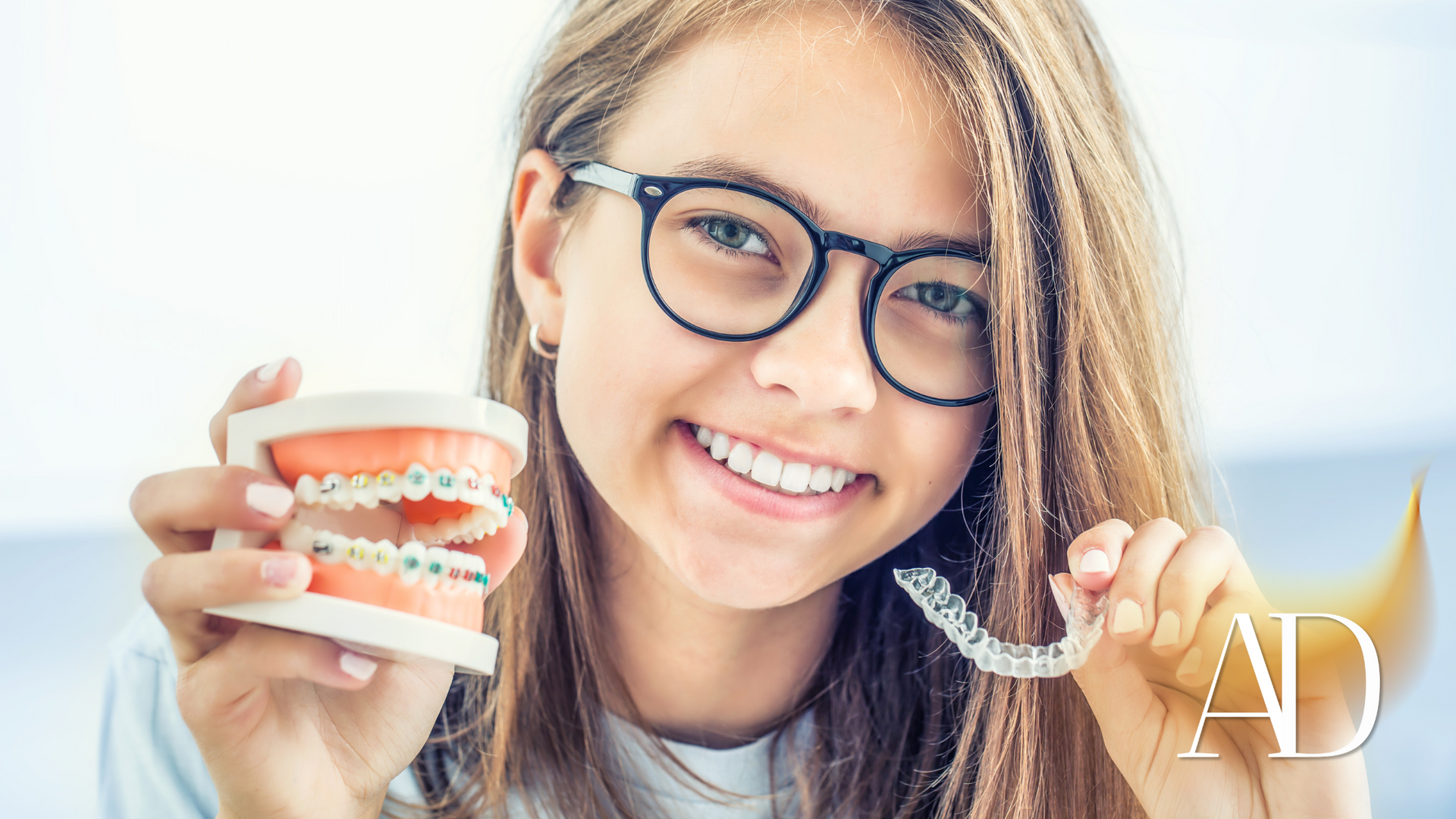 Smiling woman with glasses holding a coffee cup and clear aligners, with an “AD” label in the corner