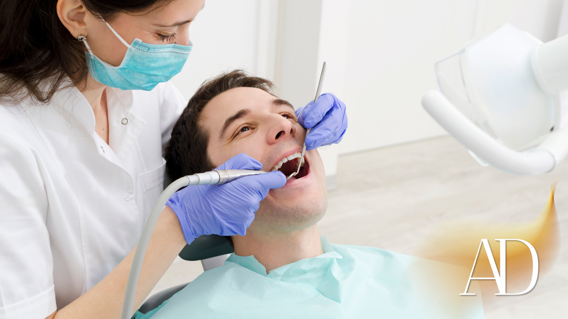 Dentist examining a patient’s mouth with tools in a bright dental clinic