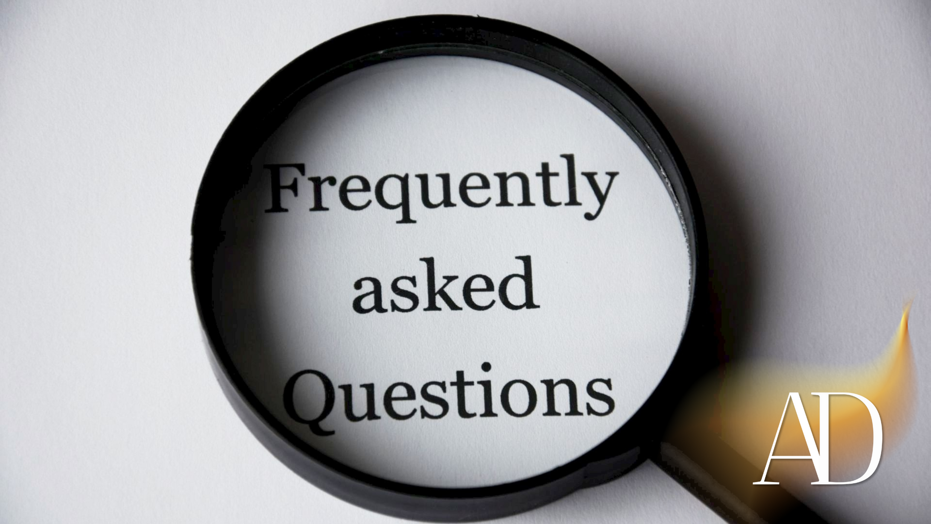 Magnifying glass over “Frequently asked Questions” text on a light background