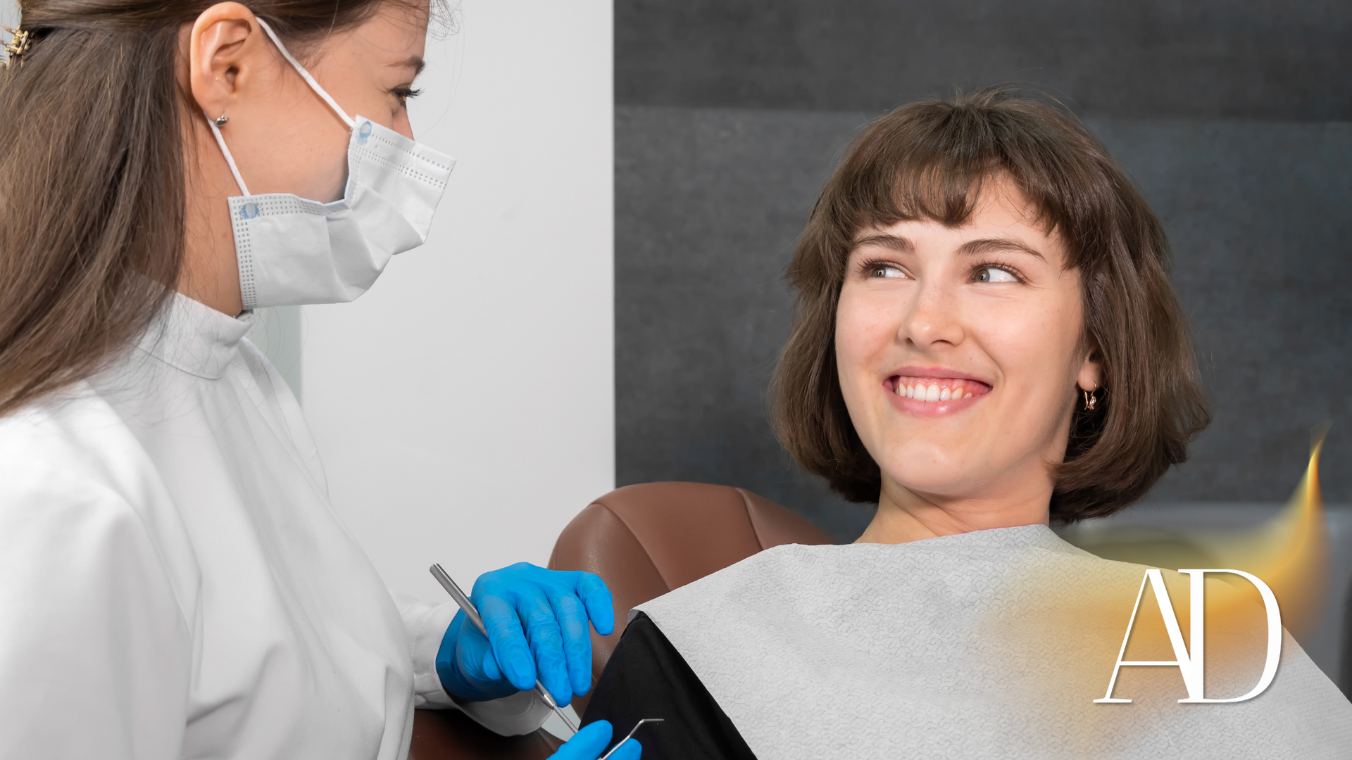 Dentist in mask and blue gloves examining a smiling patient in a dental chair