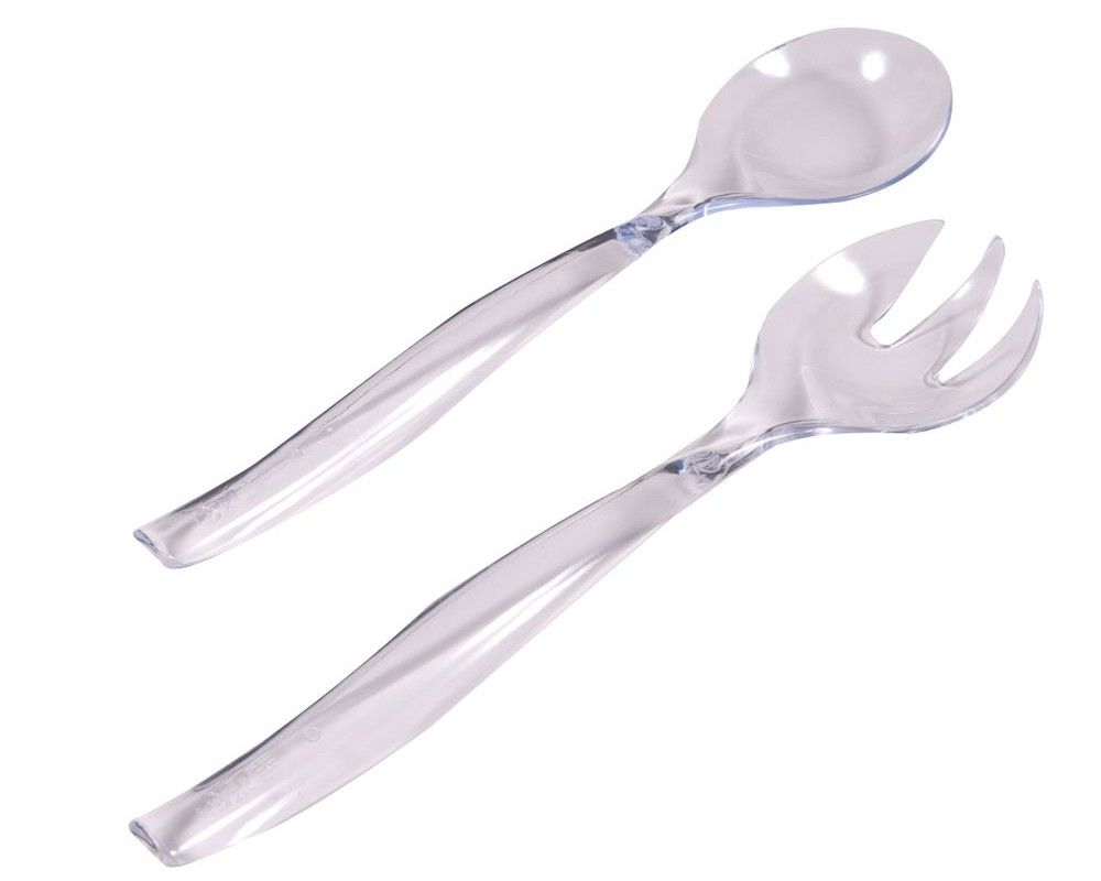 A close up of a salad spoon and fork on a white background.