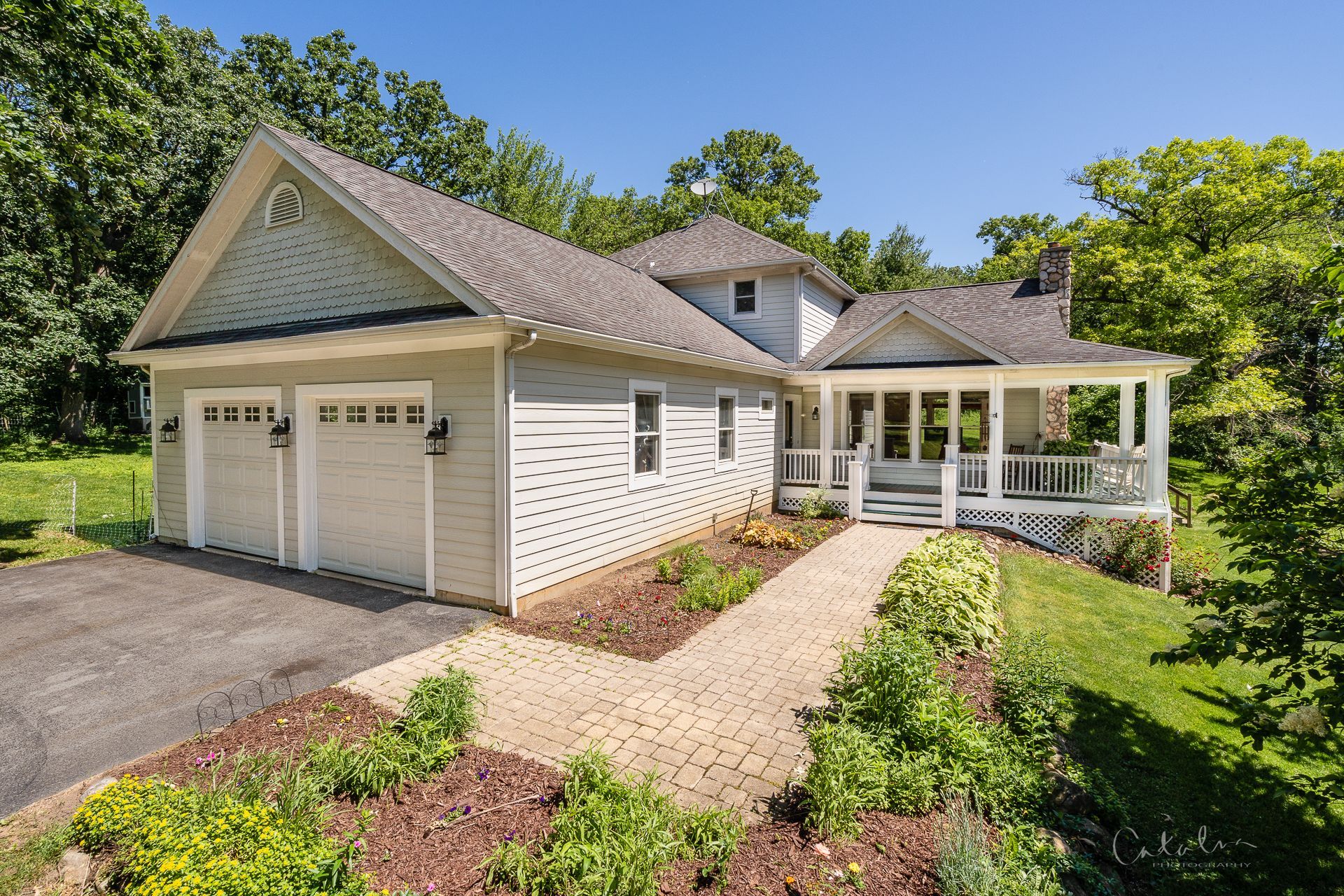 Exterior photo of a country home with a wrap around porch on 2 acres sold by Cat Cusimano, top realtor in Marengo, Illinois