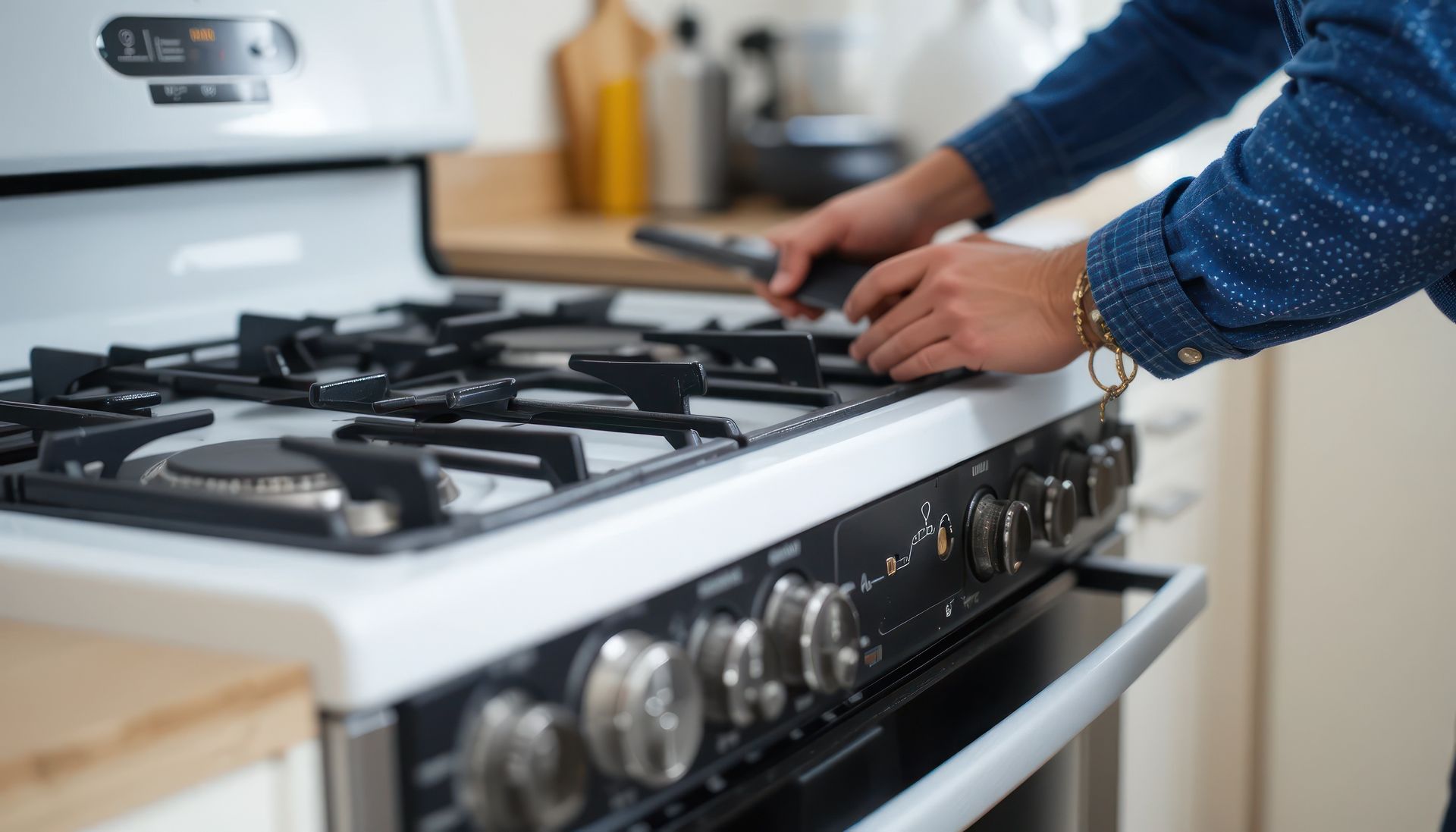 A technician adjusting burners during range stove repair service on a modern kitchen gas stove.