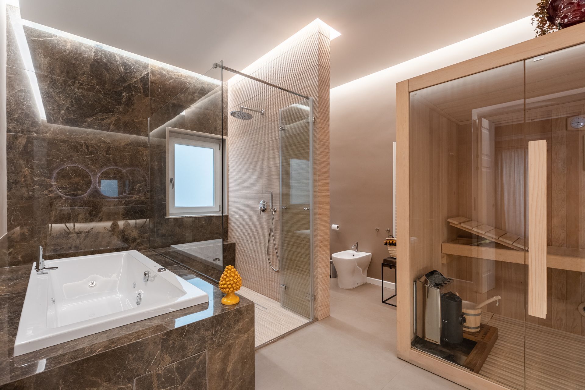 Luxurious modern bathroom with a jacuzzi, shower, and sauna. Dark marble walls, warm lighting, beige accents.