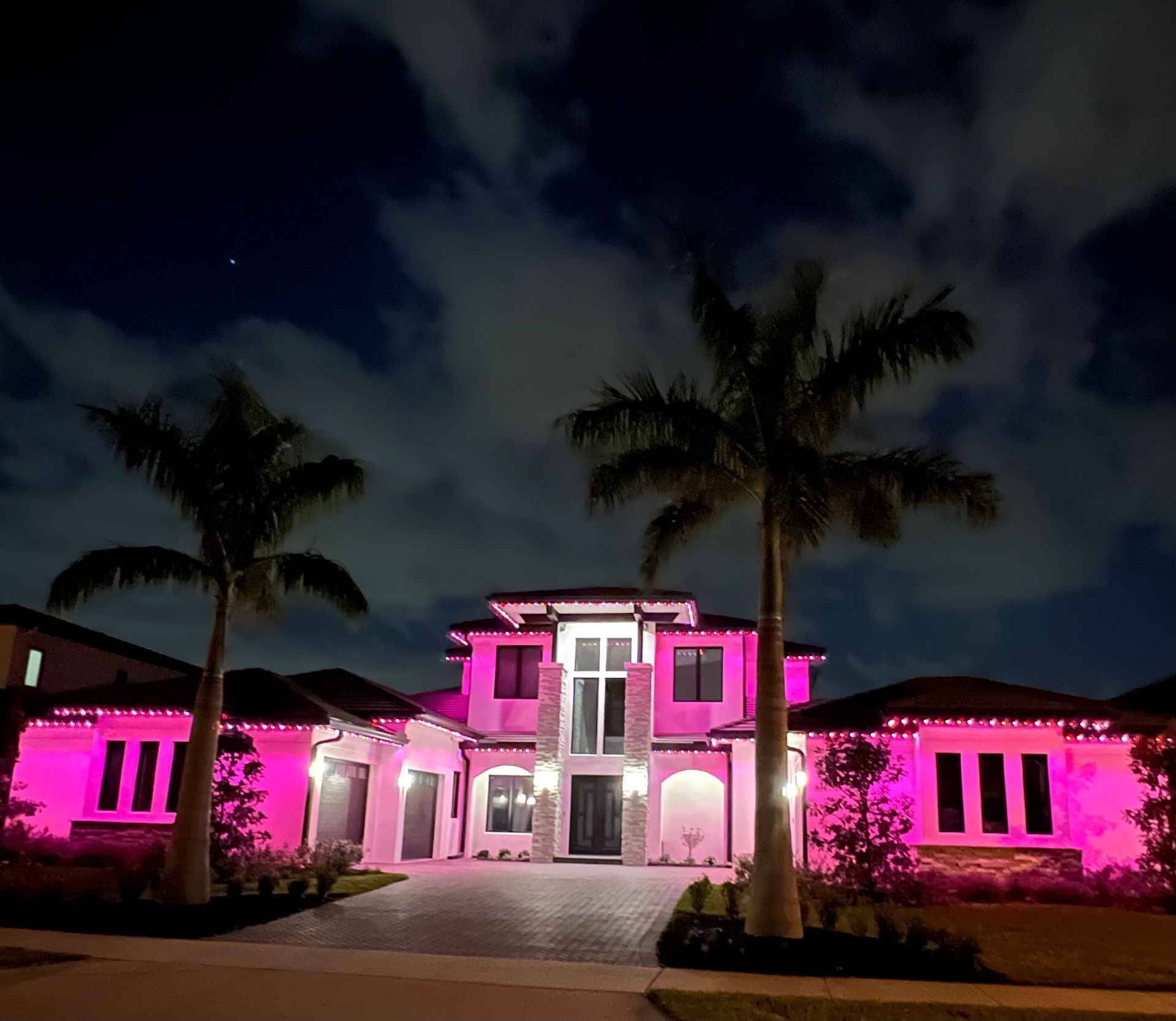 Pink lit house at night.
