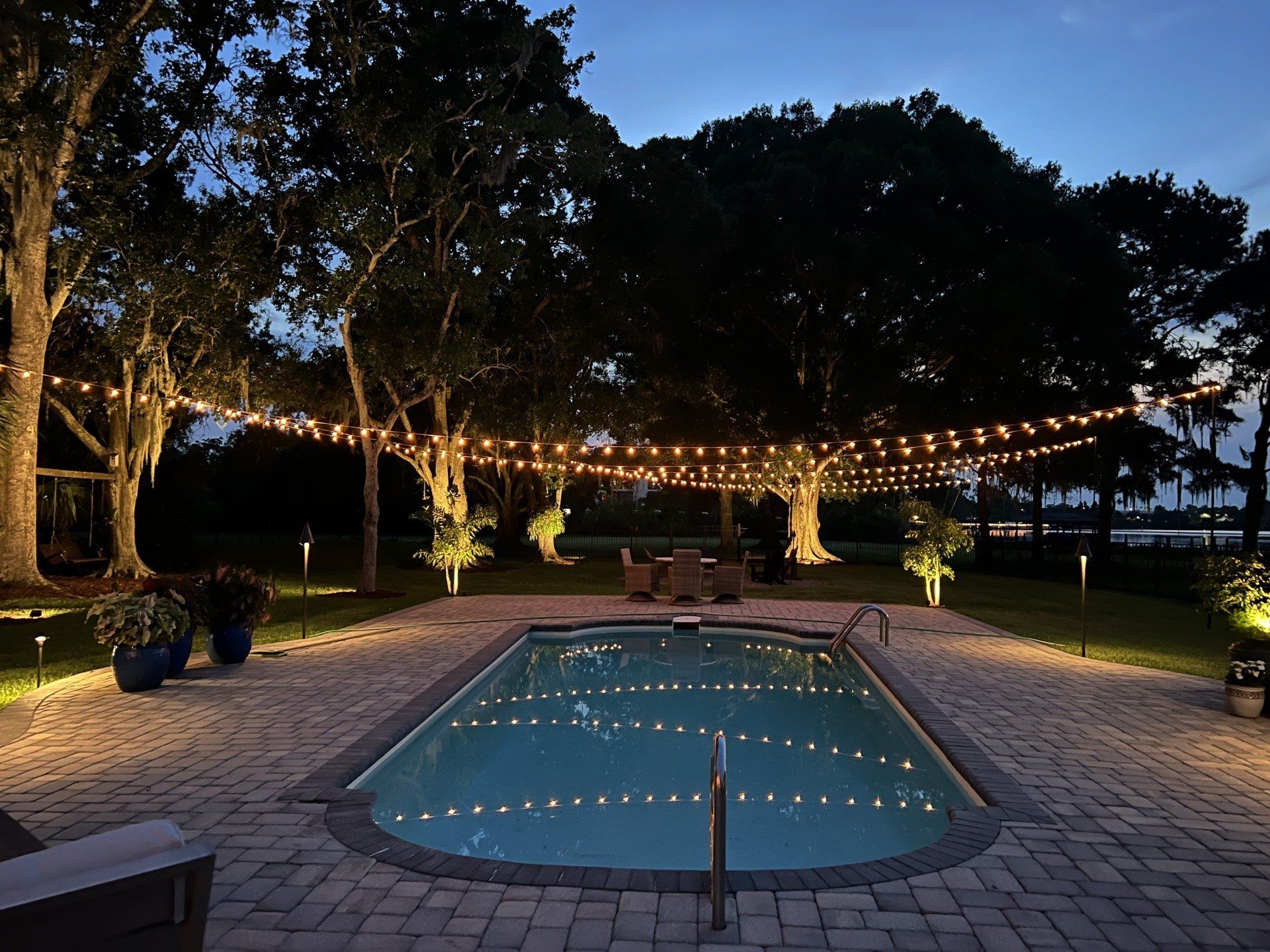 Poolside evening with string lights.
