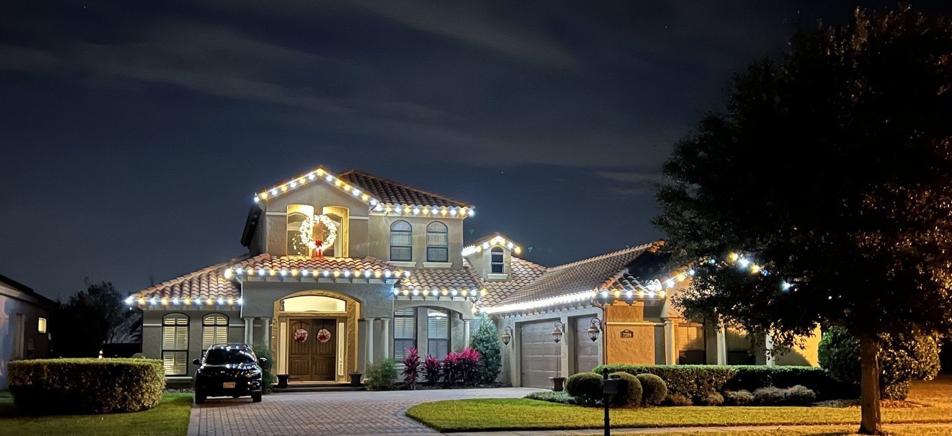 House decorated with white Christmas lights.