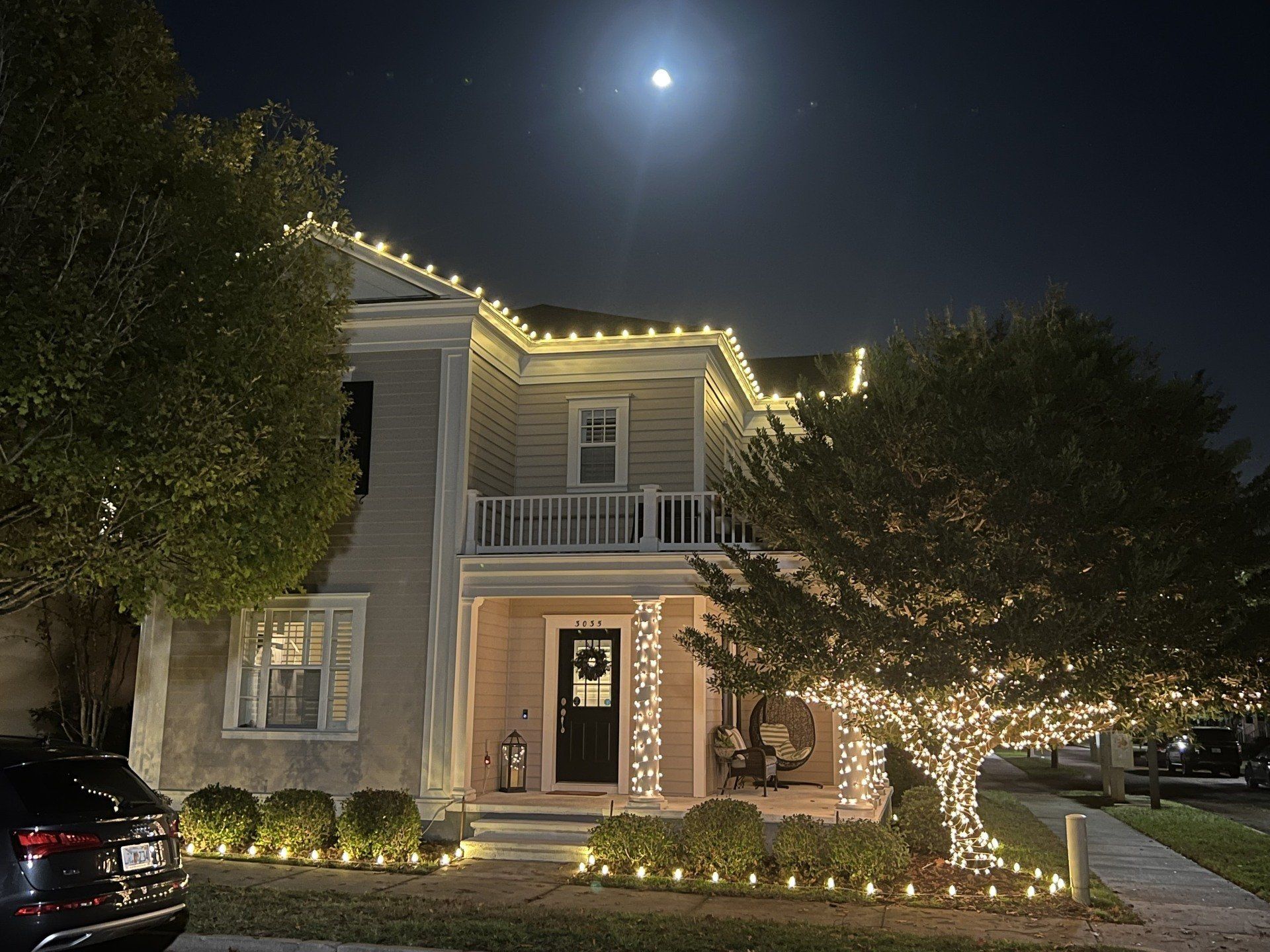 House decorated with Christmas lights at night.