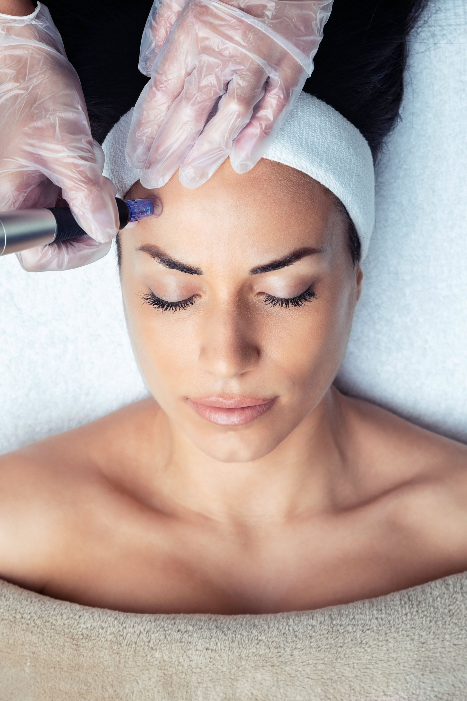 Cosmetologist making mesotherapy injection with dermapen on face for rejuvenation on the spa centre