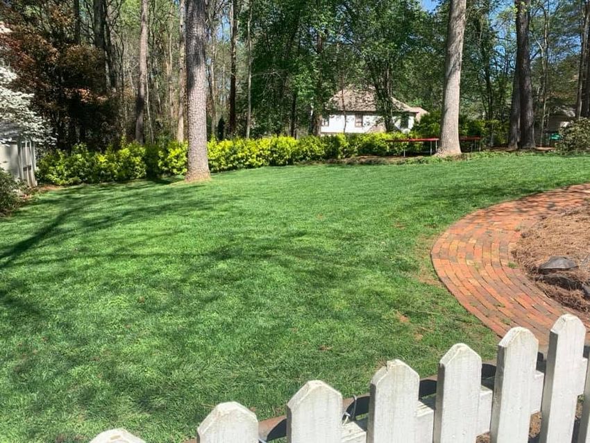 Landscaping professional maintaining a residential garden edge