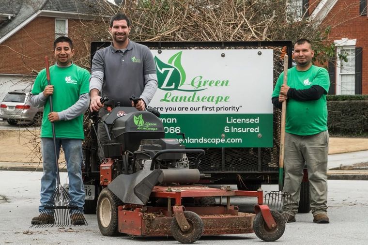 Landscaper reviewing a maintained lawn with a homeowner