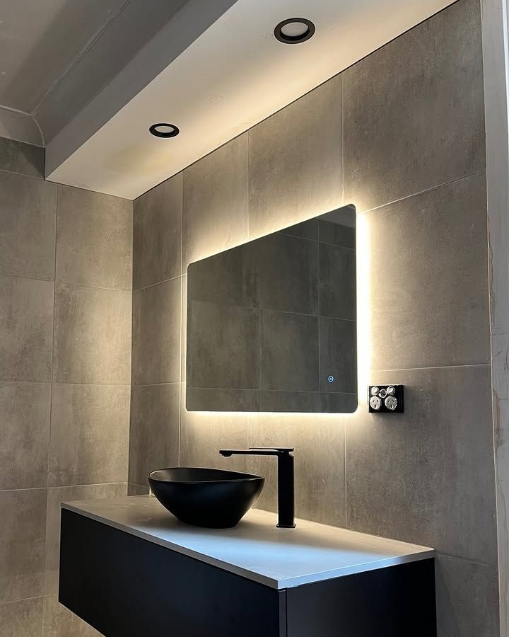 A Bathroom with A Sink and A Mirror With Lights on The Wall — Bowral Bathrooms in Exeter, NSW