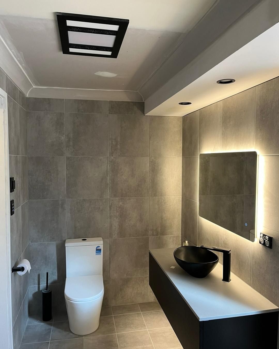 A Bathroom with A Toilet, Sink and Mirror — Bowral Bathrooms in Bundanoon, NSW