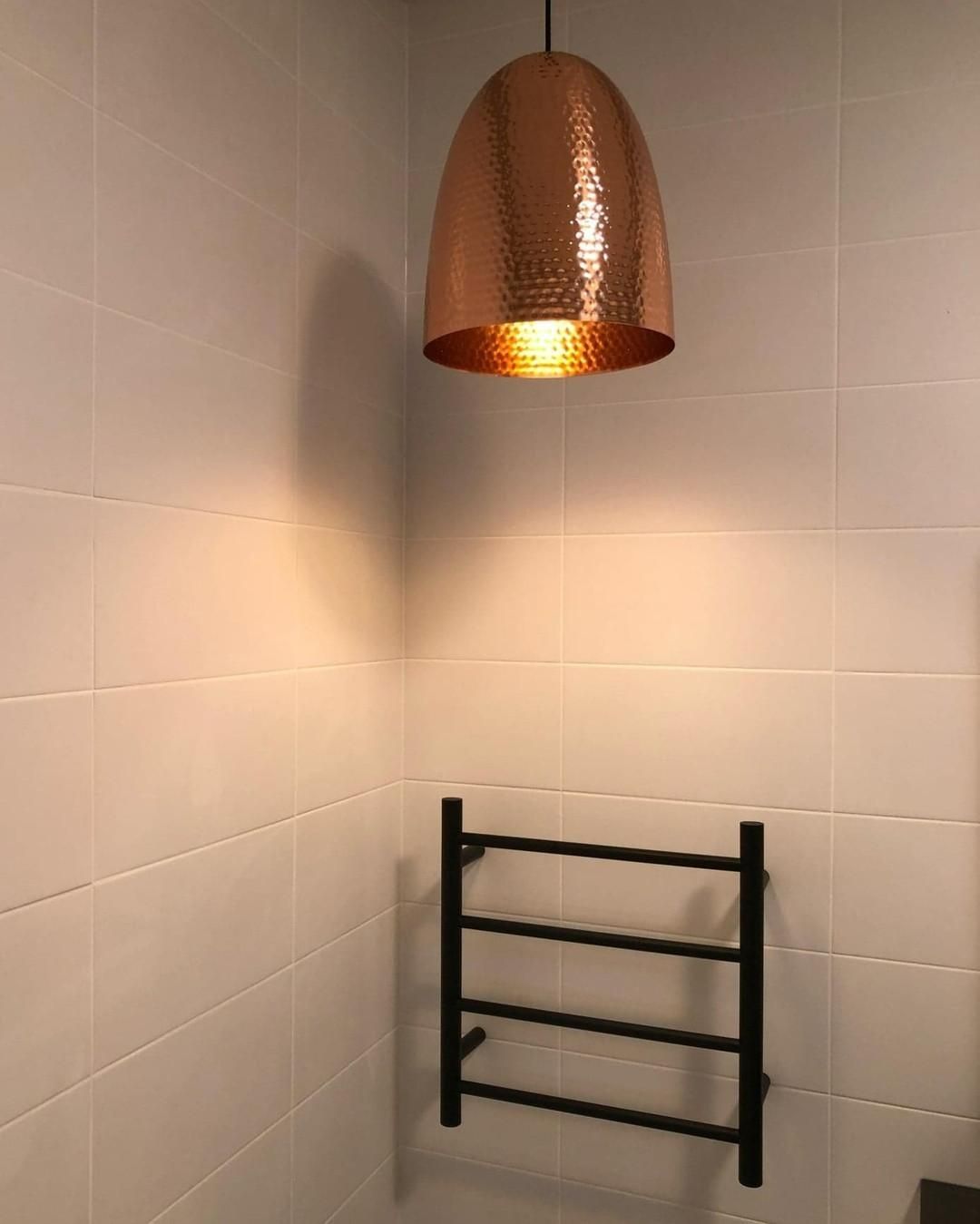 A Bathroom with A Towel Rack and A Copper Light Hanging from The Ceiling — Bowral Bathrooms in Exeter, NSW