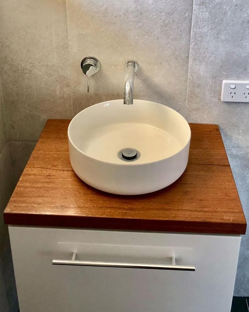 A Bathroom Sink Is Sitting on Top of A Wooden Counter — Bowral Bathrooms in Bundanoon, NSW