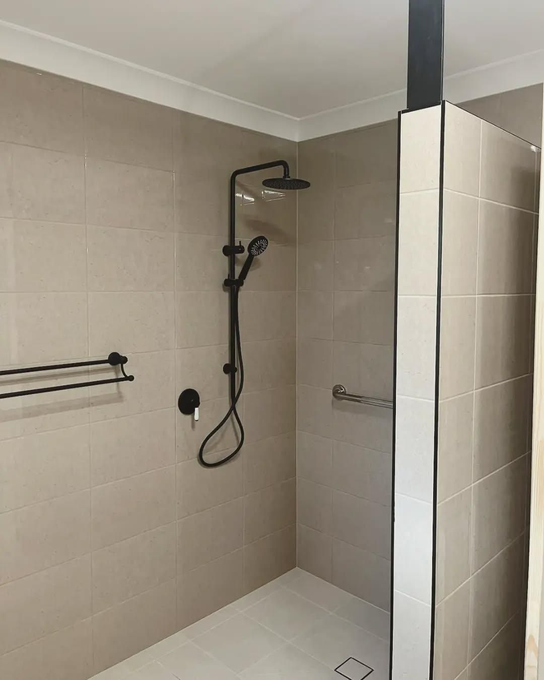 A Bathroom with A Walk in Shower and A Black Shower Head — Bowral Bathrooms in Exeter, NSW