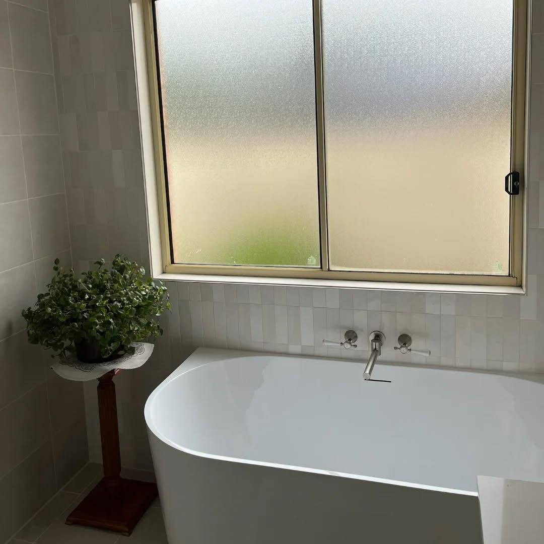 A Bathroom with A Bathtub and A Window — Bowral Bathrooms in Bowral, NSW