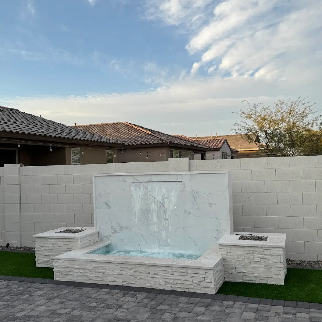 There is a waterfall in the middle of a brick wall.