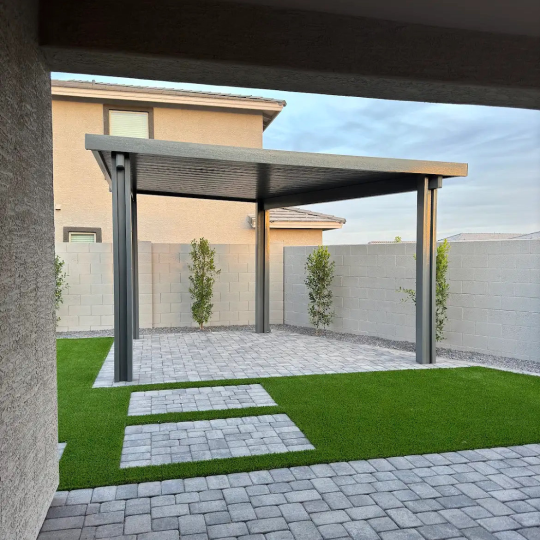 A patio with a pergola and a brick walkway