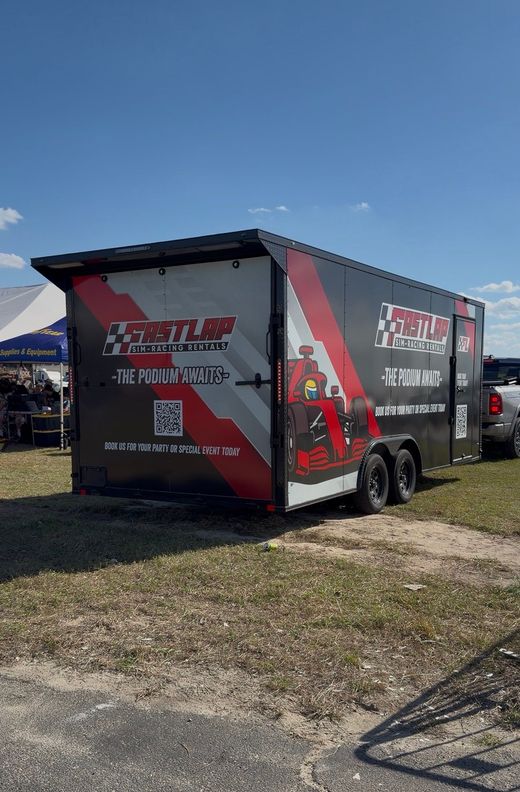 Mobile sim racing experience trailer parked at an event at Charlotte Motor Speedway