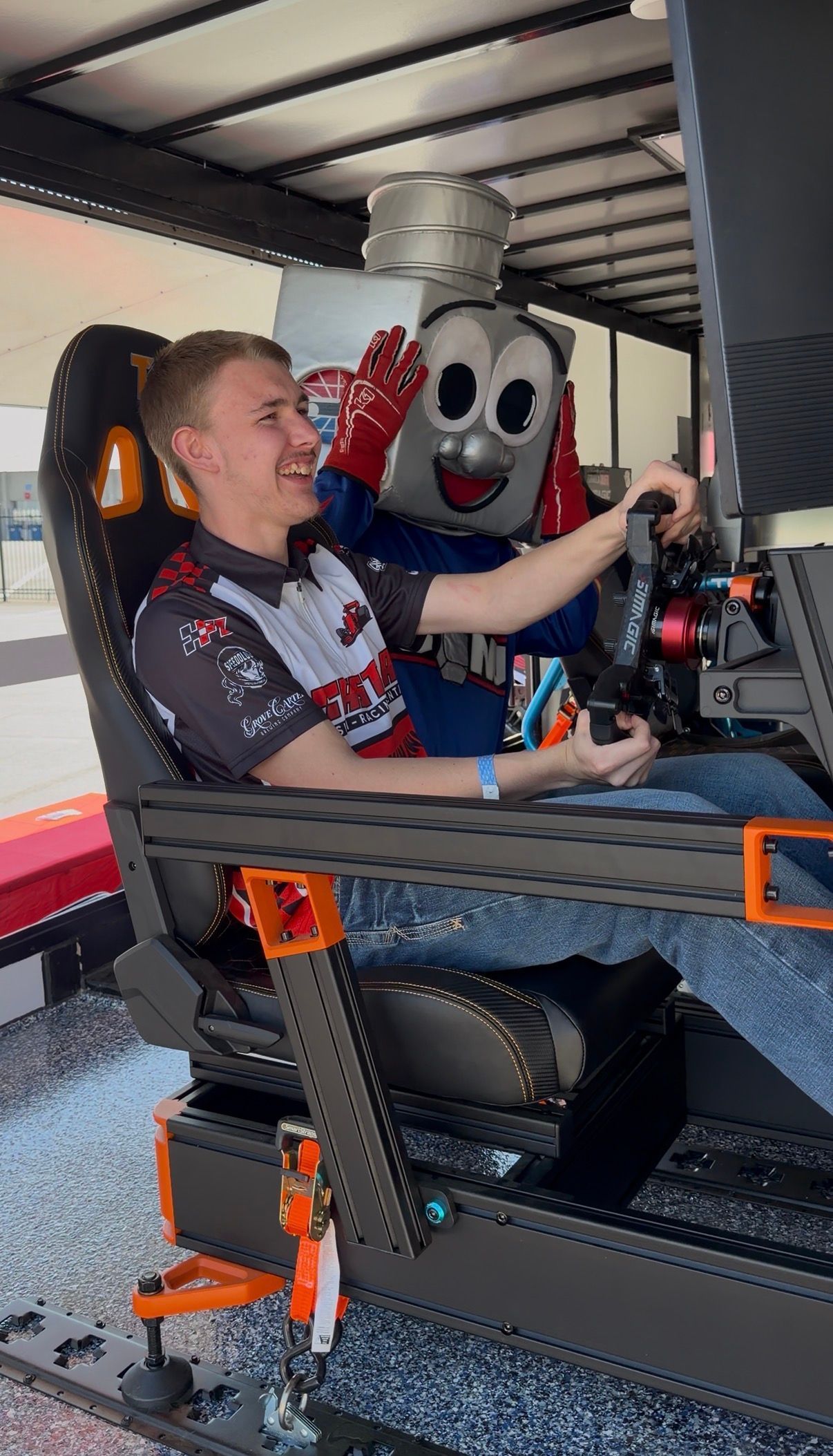 Man driving a racing simulator in a mobile sim racing experience trailer