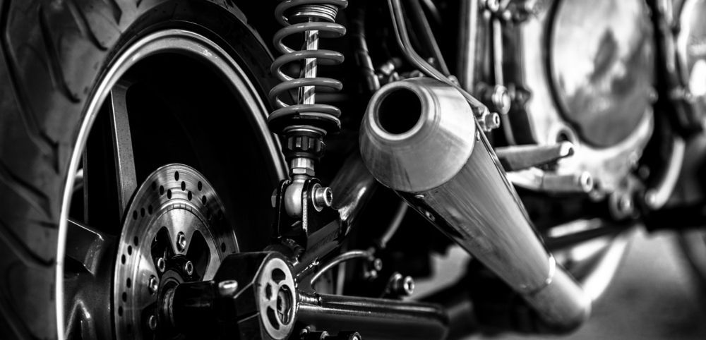 Black and White Photo of a Motorcycle With a Shock Absorber and Exhaust Pipe — 365 Towing Taree in Forster, NSW