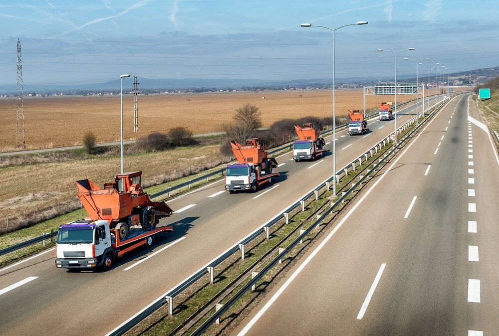 Row of Trucks Are Driving Down a Highway — 365 Towing Taree in Forster, NSW