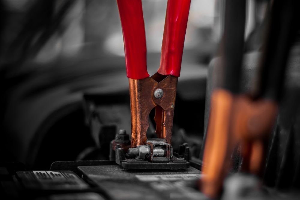 Close Up of a Pair of Pliers Attached to a Car Battery — 365 Towing Taree in Oldbar, NSW