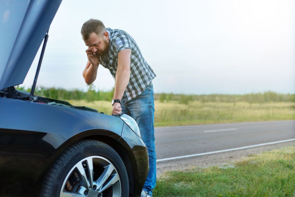 Man is Looking Under the Hood of His Broken Down Car — 365 Towing Taree in Harrington, NSW