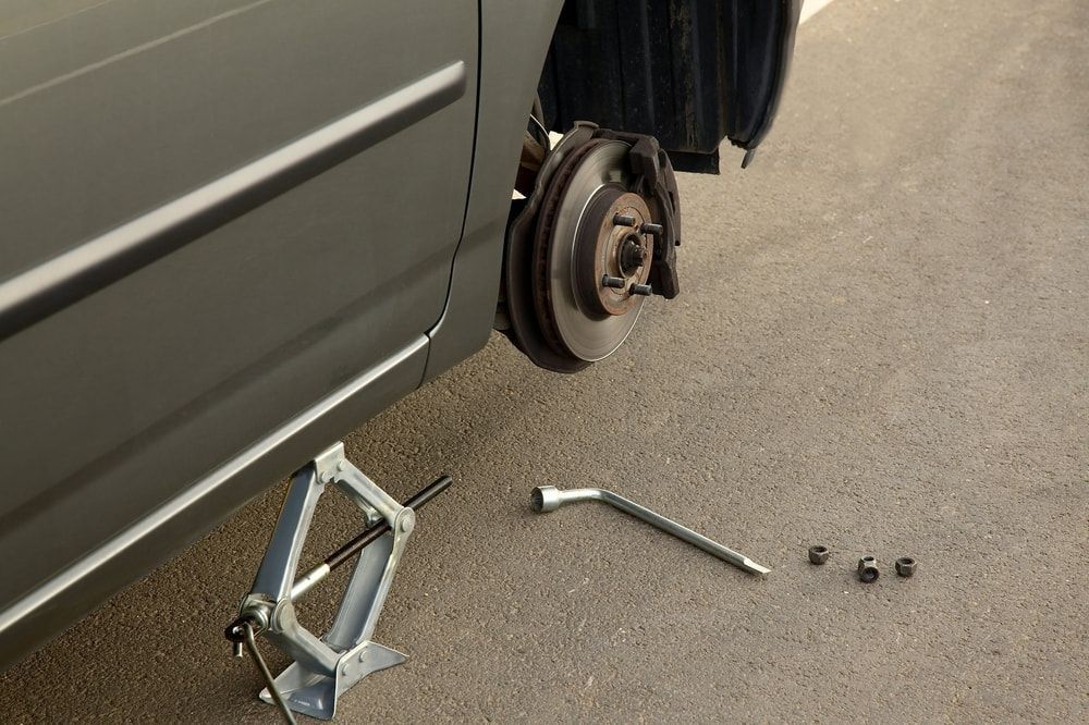 Car With a Broken Wheel is Being Changed on the Side of the Road — 365 Towing Taree in Oldbar, NSW